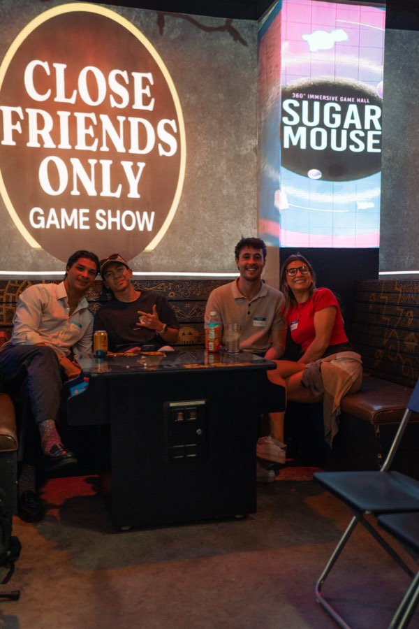 The Close Friends Only Game Show ring over a booth of four friends